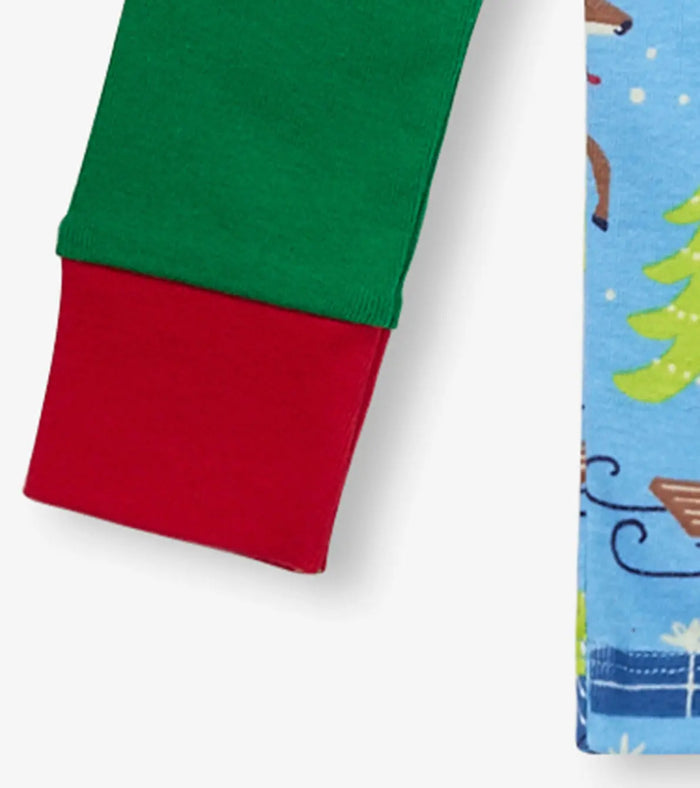 Closeup of Hatley boys raglan pajama sleeve with green fabric and red cuff trim.