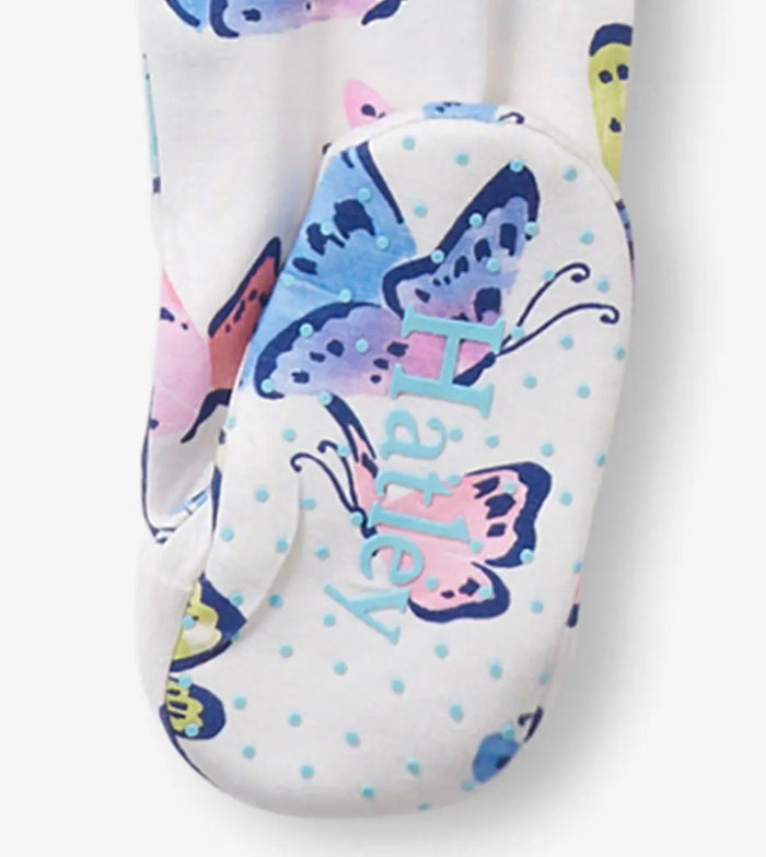 Closeup of butterfly-print footed sleeper footbed with soft printed finish.