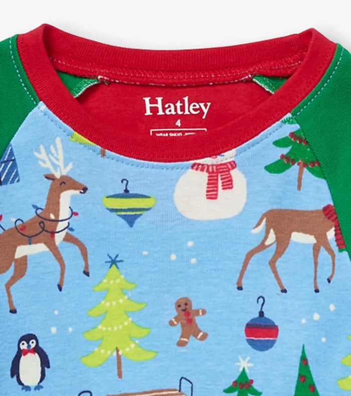 Closeup of Hatley boys Blue Christmas pajama top showing red neckline and holiday print.