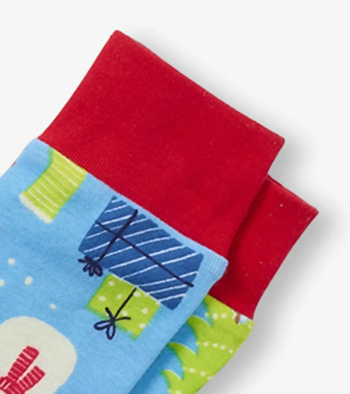 Closeup of Hatley boys organic cotton pajama cuff with red trim and Christmas print.