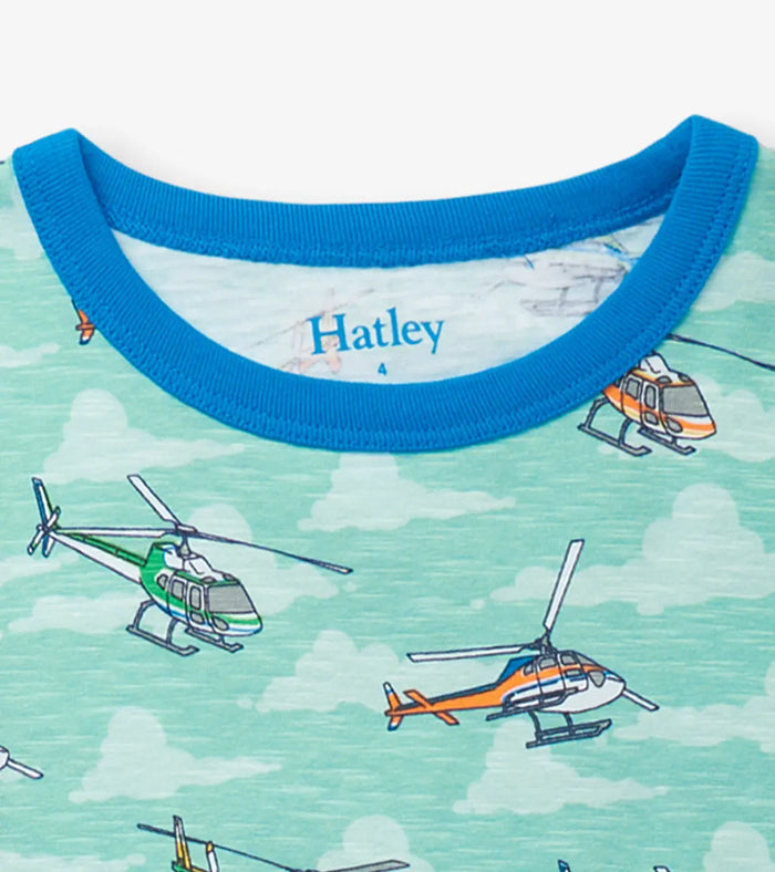 Closeup of Hatley boys pajama neckline with helicopter print, blue binding, and Hatley logo.