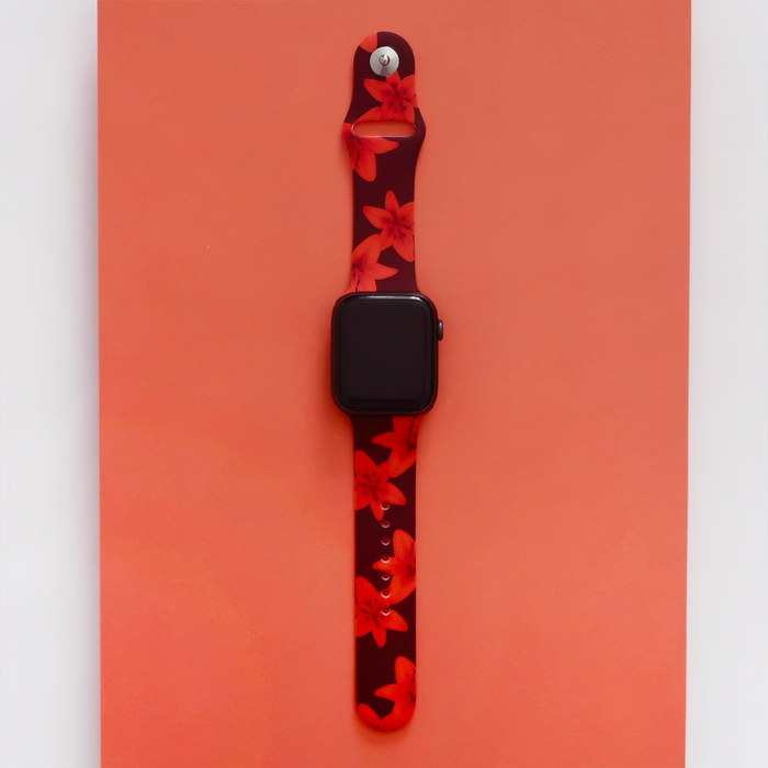 Coconut Lane Apple Watch strap with black and red floral pattern on an orange background.