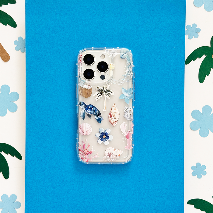 Clear phone case with seashell and flower pattern, showcasing a playful, beach-inspired design.