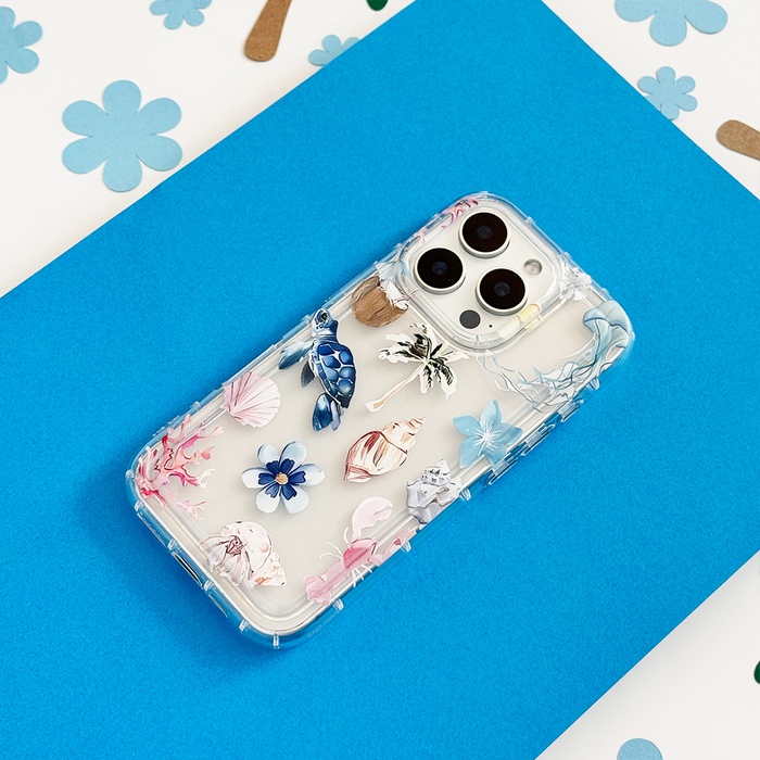 Clear blue phone case with raised seashell, flower, and ocean designs from Coconut Lane.