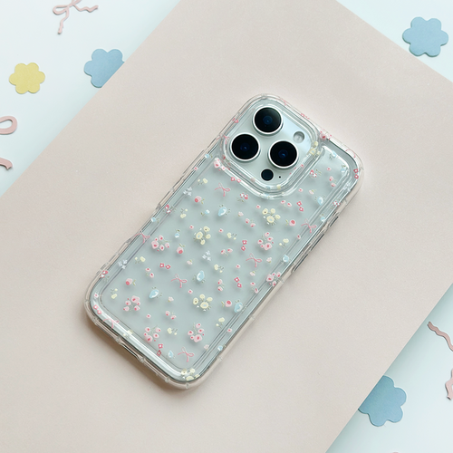 Clear Coconut Lane phone case with bow and floral design on a pale pink surface.