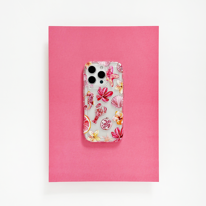 Clear Coconut Lane Rosé Coast phone case on a smartphone, resting on a bright pink sheet with white background.