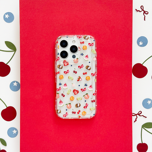 Clear phone case with colorful fruit illustrations and cherry accents on a red background.