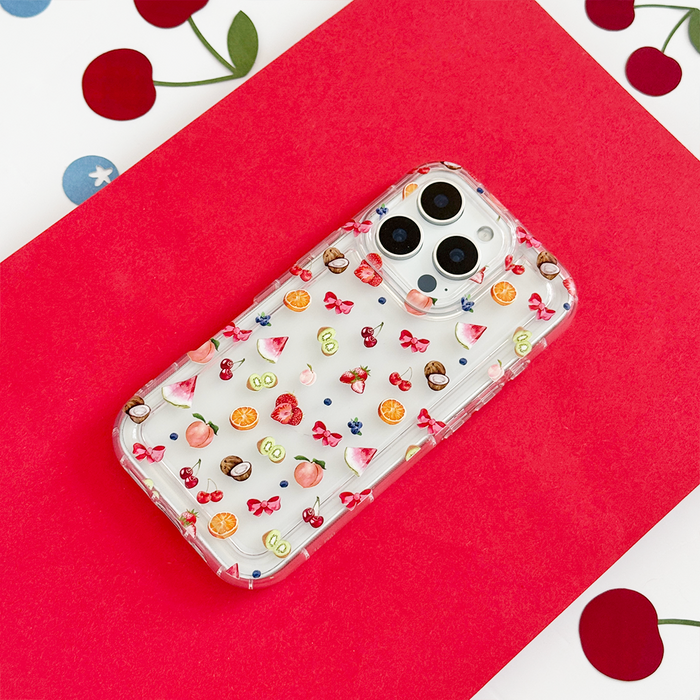 Clear phone case with colorful fruit and bow pattern on a red and white background.