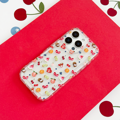 Clear phone case with colorful fruit and bow pattern on a red and white background.