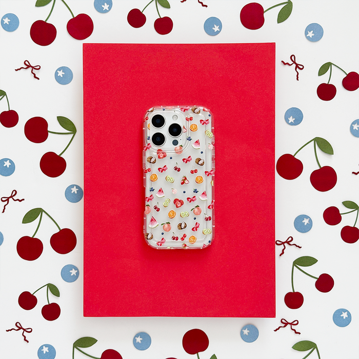Clear phone case with colorful cherry and star pattern on a red background.