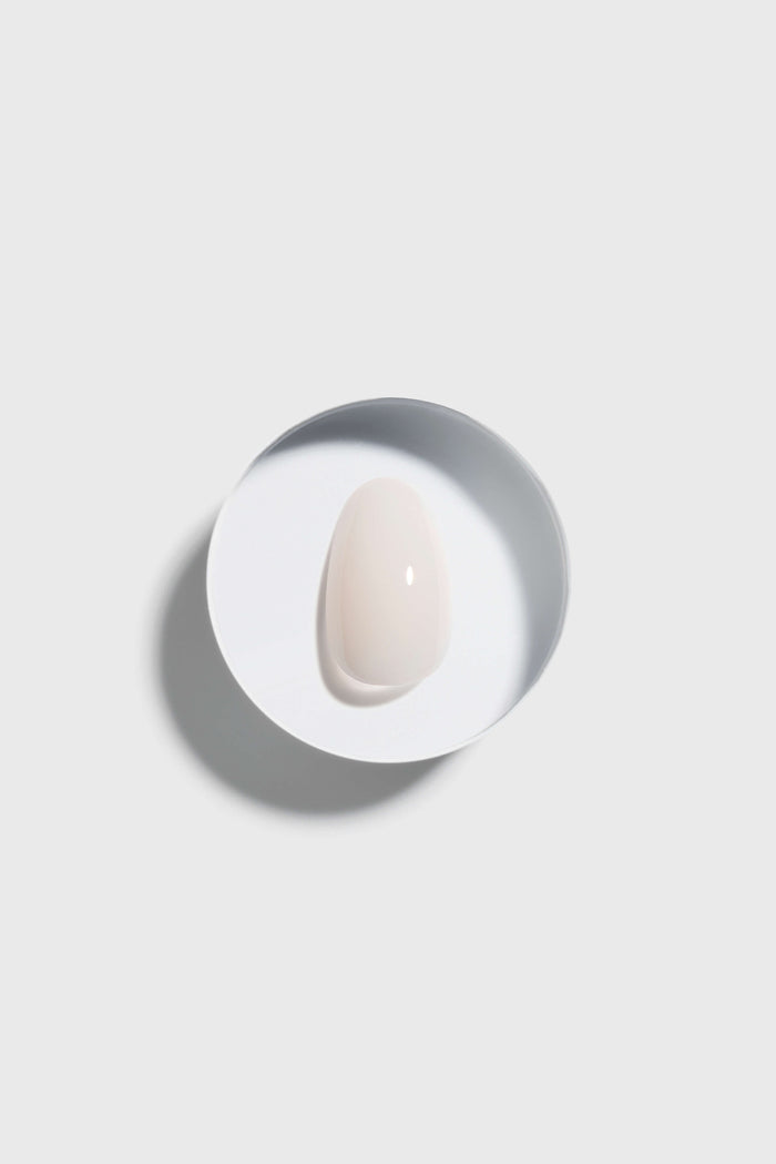 light pink press-on nail on white ceramic plate