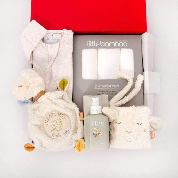 Signature red box including a cotton comforter sheep,  an interactive book, lavender al.ive oil, an organic cotton romper, and three muslin swaddles. Price: 210