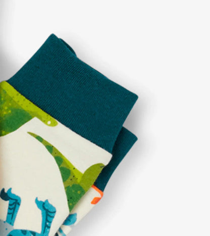 Closeup of Hatley boys pajama cuff with dark green trim and colorful dinosaur print.
