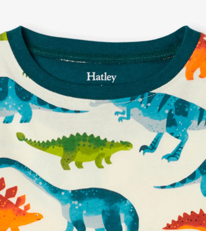 Closeup of Hatley boys Dinosaur Park pajama top showing green neckline and prehistoric print.