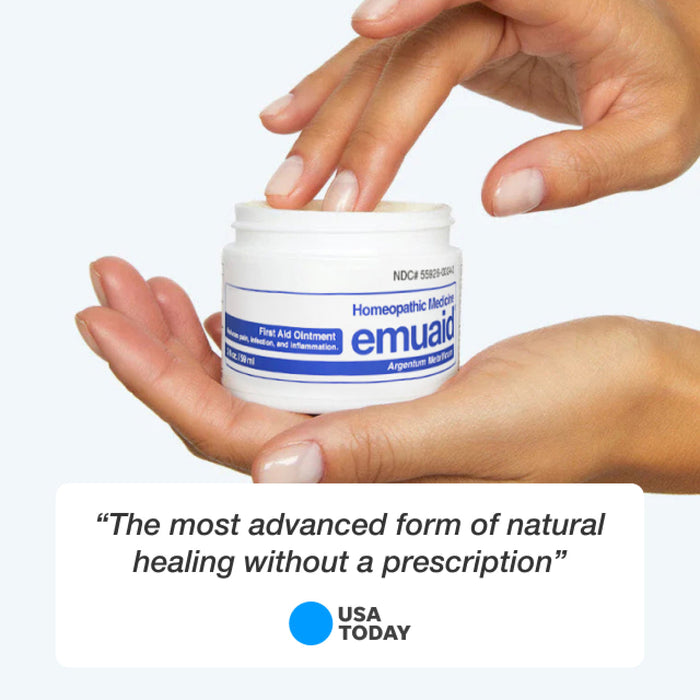 hands holding emuaid first aid ointment