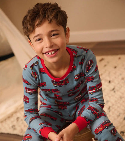 Boy wearing Hatley Firetrucks pajamas with soft organic cotton and snug-fitting comfort.