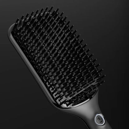 Black hairbrush on a dark background