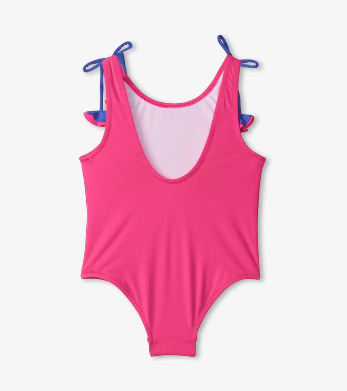 Back view of Hatley girls pink unicorn swimsuit with scoop back and bow straps