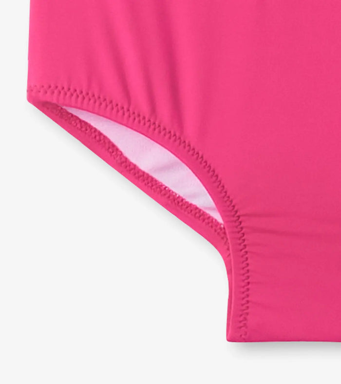 Close-up of Hatley pink one-piece swimsuit fabric and leg opening detail