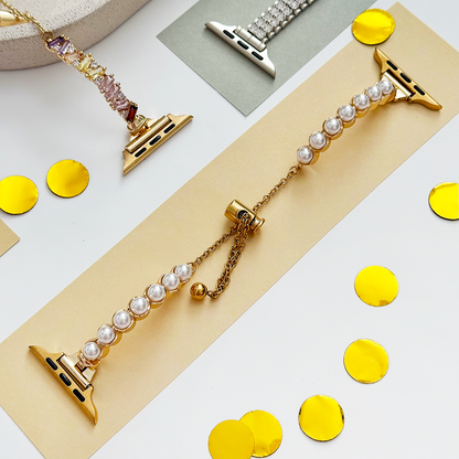 Gold Coconut Lane Isla Pearl Apple Watch strap on colored paper with gold confetti.