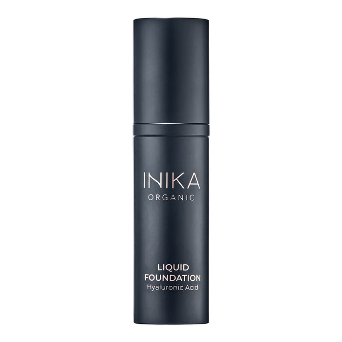 Black bottle of INIKA Organic Liquid Foundation on a white background.