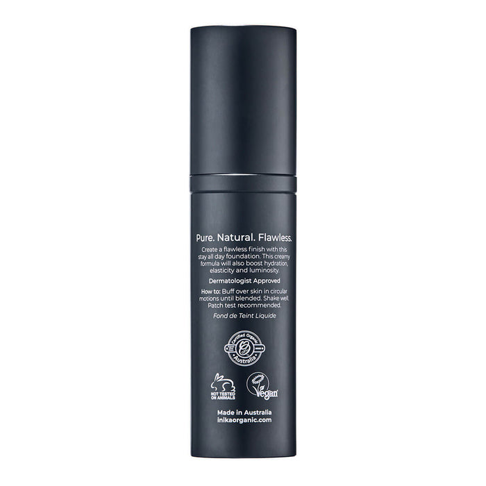 Back of black bottle of INIKA Organic Liquid Foundation on a white background.