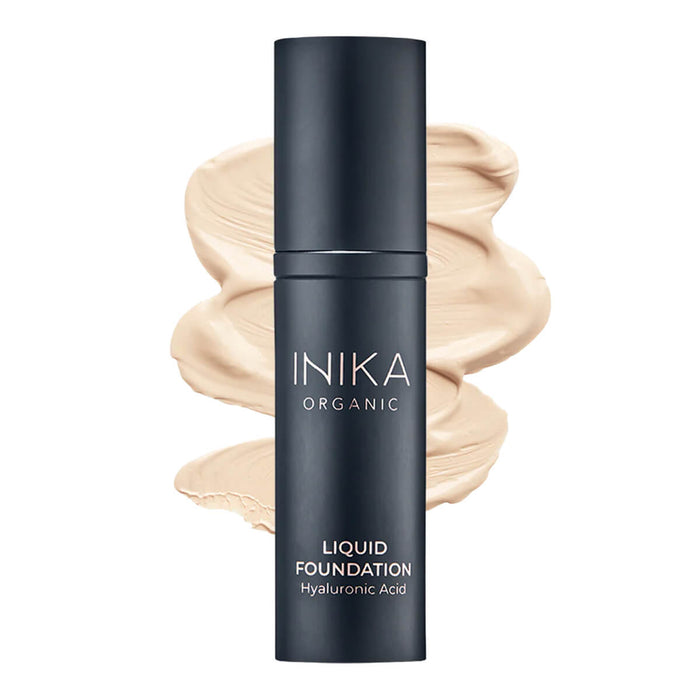 Bottle of INIKA Organic Liquid Foundation with a cream-coloured swatch behind it.