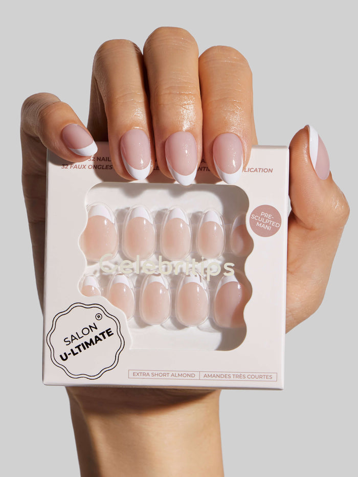 Hand holding a box of 'Salon U-Ltimate' press-on nails in a matching color.