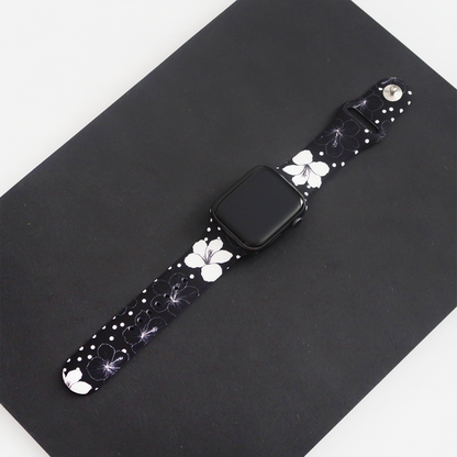 Coconut Lane Mono Flora Apple Watch strap with a black and white floral pattern displayed on a black surface.