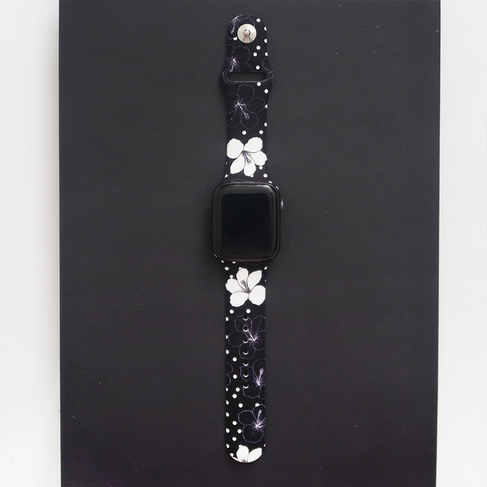 Black Apple Watch strap with white flowers and polka dots from Coconut Lane.