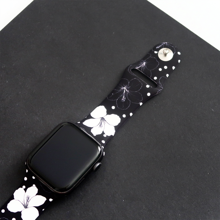 Black Apple Watch strap with white and black floral pattern.