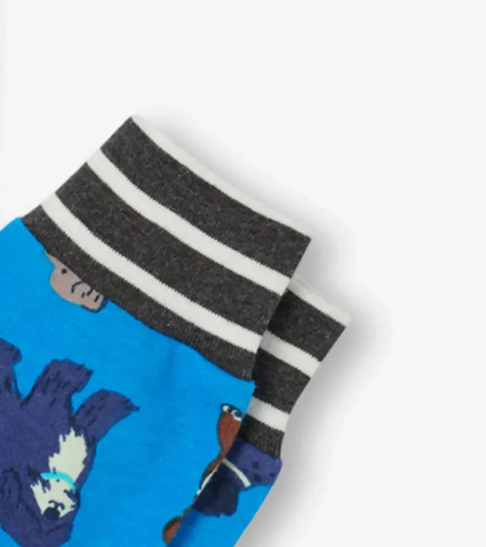 Closeup of Hatley boys Playful Puppies print showing colorful dogs on blue organic cotton pajamas.