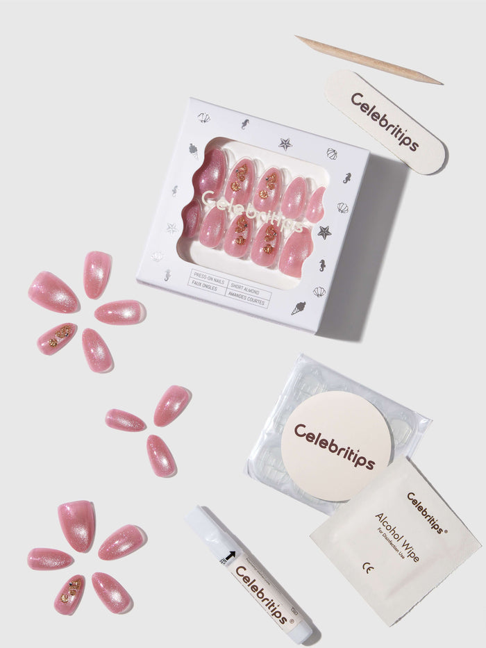 Celebritips nail art kit with pink nail tips, alcohol wipes, and a cotton pad on a white background.