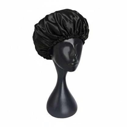 Black satin bonnet on a black mannequin head against a white background