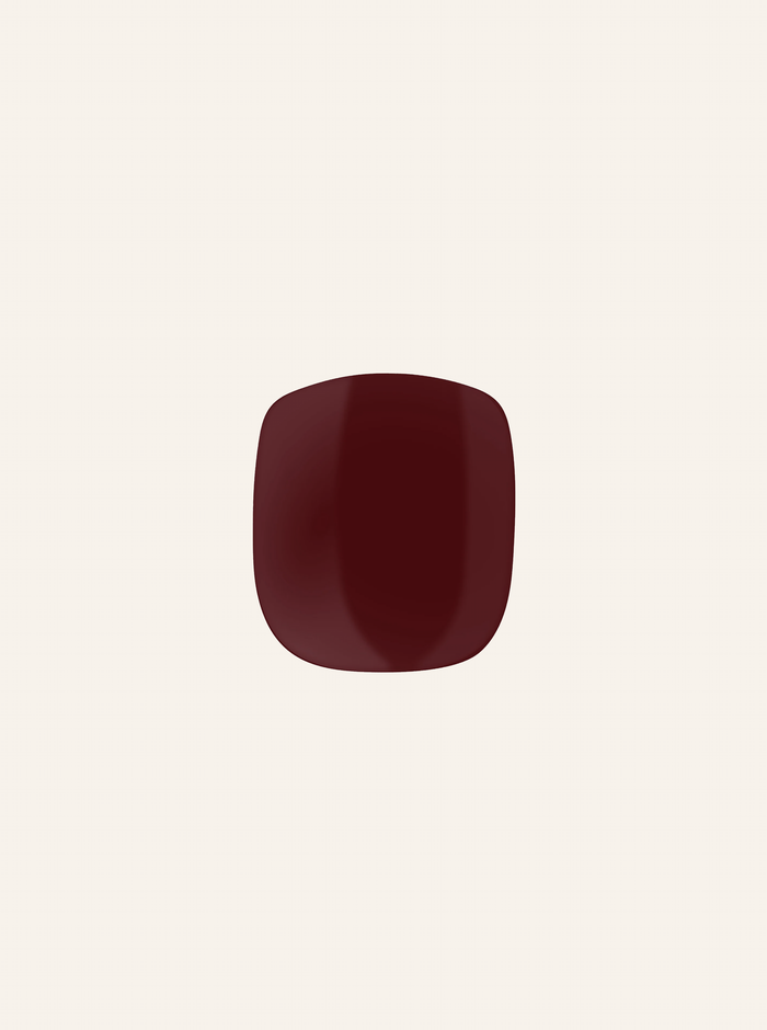 A single red-colored gel nail sticker against a white background, representing a pedicure product.