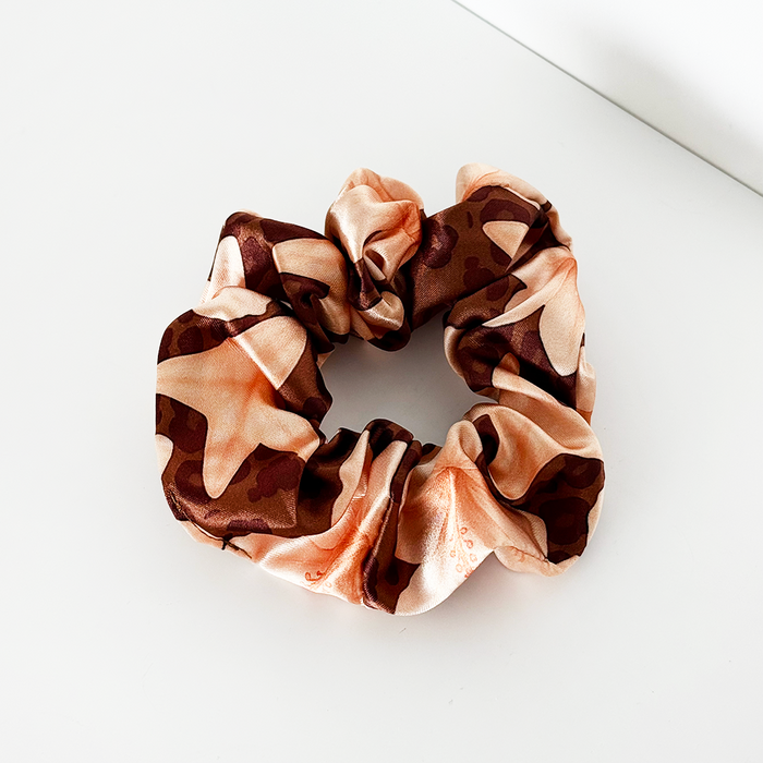 Brown-beige scrunchie with safari print and starfish accents, made from soft fabric.