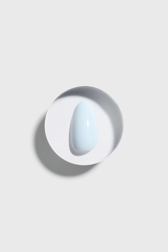 sky blue press-on nail on a white background