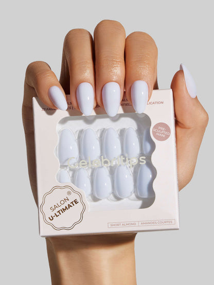 Hand holding a box of blue press-on nails with Salon U-ltimate branding.