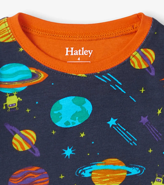 Closeup of Hatley boys Space Explorer pajama top showing orange neckline and planet print.