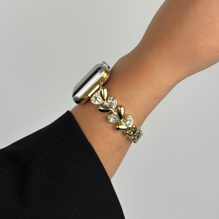 Gold Sparkle Petal Apple Watch strap by Coconut Lane on a wrist, shown against a plain background.
