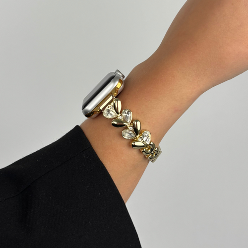 Gold Sparkle Petal Apple Watch strap by Coconut Lane on a wrist, shown against a plain background.