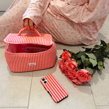 Cherry Stripes Tough Phone Case on bathroom floor next to roses
