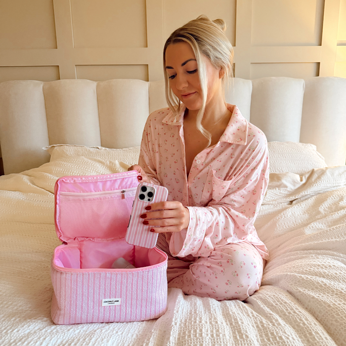 Girl placing Powder Stripes Tough Phone Case into the Powder Stripes Vanity Case