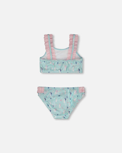 Flat view of Deux par Deux girls two-piece swimsuit showing frilled top and seahorse swim bottoms.