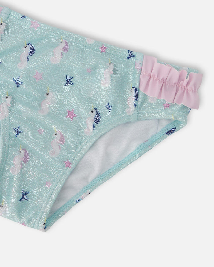 Closeup of Deux par Deux swim bottoms showing Blue/Pink seahorse print, frill trim, and stretch fabric.