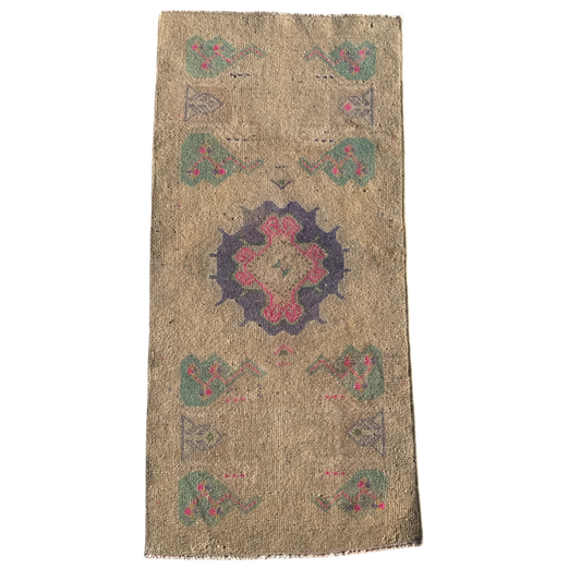 Decorative rug with a central floral design on a beige background